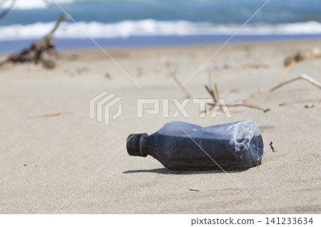 Crushed plastic containers washed ashore on the beach Crushed plastic containers washed ashore on the beach 141233634