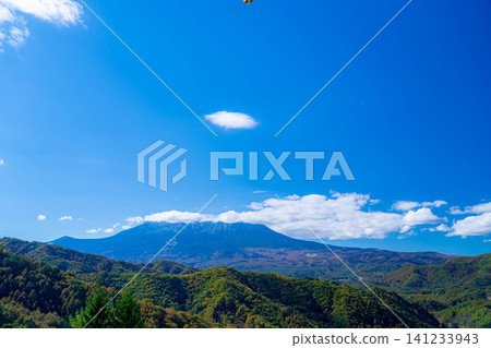 [Autumn foliage image] Mount Ontake shrouded in clouds, as seen from Kyuzo Pass in Kaida Plateau in autumn [Nagano Prefecture] 141233943