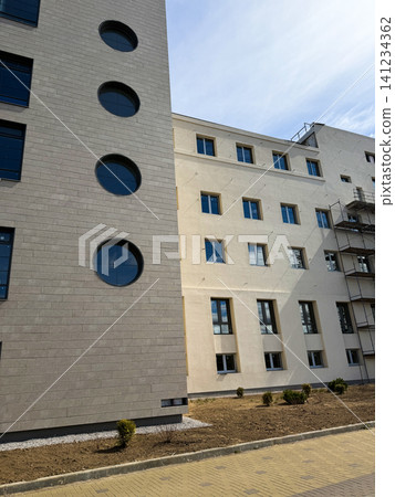 New apartment building and real estate property development, contemporary office corporate exterior with round windows. New apartment building and real estate property development, contemporary office corporate exterior with round windows. 141234362