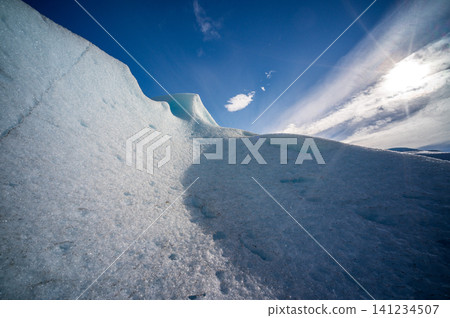 Perito moreno glaciers ice landscape blue sky frozen ridge under bright sun with textured snow and cloud over patagonia Perito moreno glaciers ice landscape blue sky frozen ridge under bright sun with textured snow and cloud over patagonia 141234507