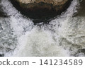 Dangerous river floods with swirling muddy waters 141234589