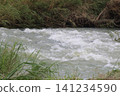 A flood scene of muddy torrents overflowing due to heavy rain. 141234590