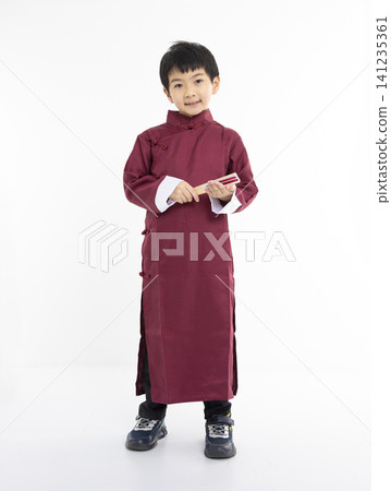 Smiling cute Asian boy in traditional Chinese clothing Smiling cute Asian boy in traditional Chinese clothing 141235361