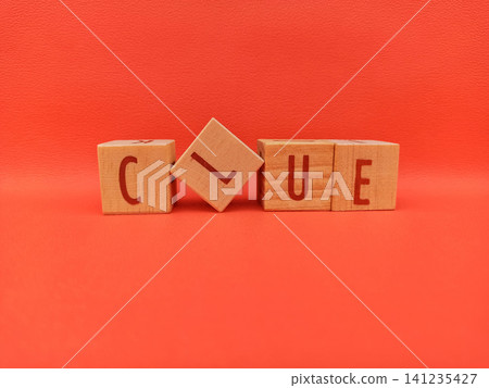 Wooden Blocks Spell Out Clue Against Red Background Wooden Blocks Spell Out Clue Against Red Background 141235427