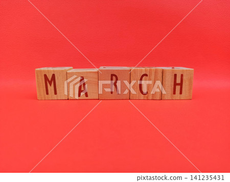Wooden Blocks Spell March on Bright Red Background Wooden Blocks Spell March on Bright Red Background 141235431