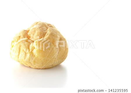 A cream puff photographed alone against a white background. A cream puff photographed alone against a white background. 141235595
