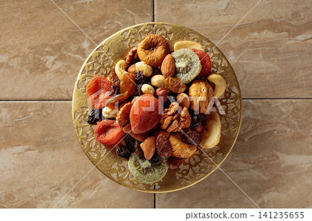 Assortment of dried tropical fruits, nuts and raisins. Assortment of dried tropical fruits, nuts and raisins. 141235655
