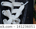 Background image of a left black sneaker with white laces, featuring open space on the side for text. 141236051