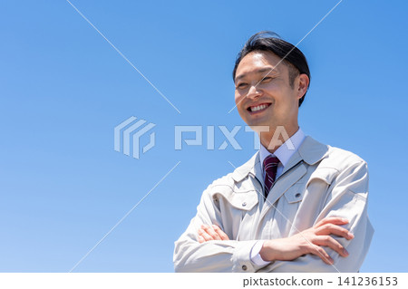 Blue sky and businessmen in work clothes Blue sky and businessmen in work clothes 141236153