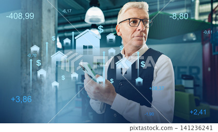 Travel booking expert checks prices on phone in a modern office while looking at data on real estate trends Travel booking expert checks prices on phone in a modern office while looking at data on real estate trends 141236241