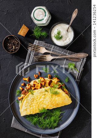 Egg omelet with fried wild chanterelles and dill Egg omelet with fried wild chanterelles and dill 141236254