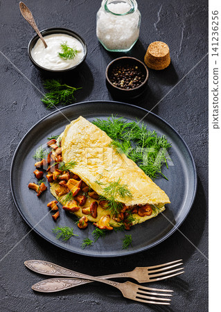 Egg omelet with fried wild chanterelles and dill Egg omelet with fried wild chanterelles and dill 141236256