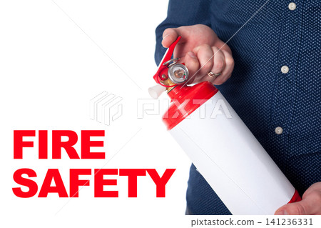 Focus on fire safety with a fire extinguisher held by a person in a blue shirt Focus on fire safety with a fire extinguisher held by a person in a blue shirt 141236331