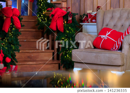 Cozy Christmas room with decorated tree, armchair, and festive holiday decor Cozy Christmas room with decorated tree, armchair, and festive holiday decor 141236335