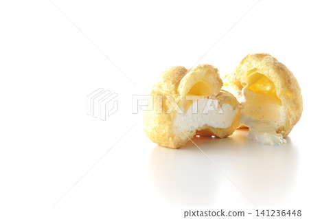 A cream puff photographed alone against a white background. A cream puff photographed alone against a white background. 141236448