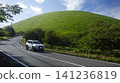 A white off-road SUV (Toyota) driving on a road near Mt. Omuro (Izu Kogen) in early summer. 141236819