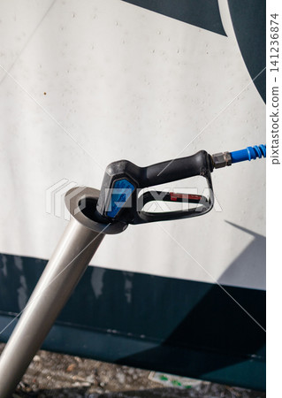 Pressure washer spray nozzle injector placed in socket at carwash station. Pressure washer spray nozzle injector placed in socket at carwash station. 141236874