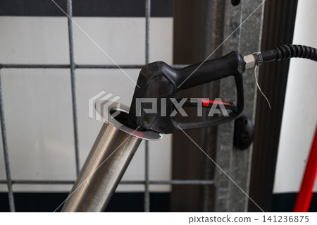 Professional active foam gun with red hose in metal holder at self-service car wash. Professional active foam gun with red hose in metal holder at self-service car wash. 141236875