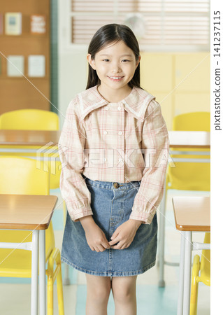 Young student presenting in a bright classroom Young student presenting in a bright classroom 141237115