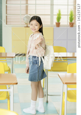 Young student presenting in a bright classroom Young student presenting in a bright classroom 141237127