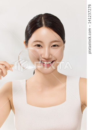 Beauty portrait of an Asian woman framed by clear glass tubes Beauty portrait of an Asian woman framed by clear glass tubes 141237276