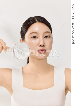 Young woman with glass laboratory rods for a clean skincare concept Young woman with glass laboratory rods for a clean skincare concept 141237277