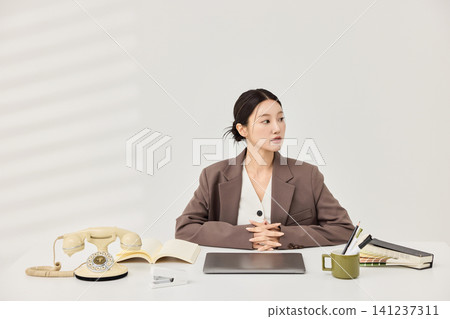 Businesswoman presenting a laptop in a bright minimalist office Businesswoman presenting a laptop in a bright minimalist office 141237311