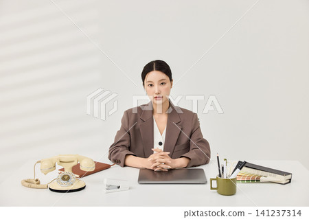 Female office worker reviewing color swatches and documents Female office worker reviewing color swatches and documents 141237314