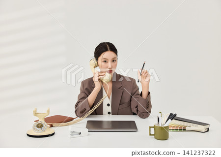 Female office worker reviewing color swatches and documents Female office worker reviewing color swatches and documents 141237322