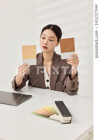 Businesswoman presenting a laptop in a bright minimalist office Businesswoman presenting a laptop in a bright minimalist office 141237344