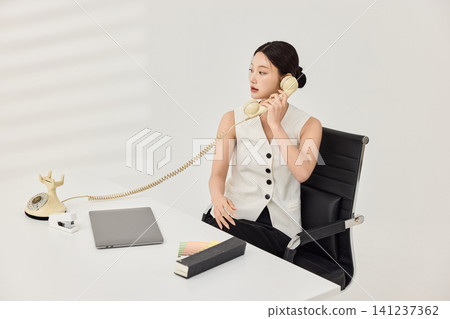 Professional woman holding a pen during office planning work 141237362