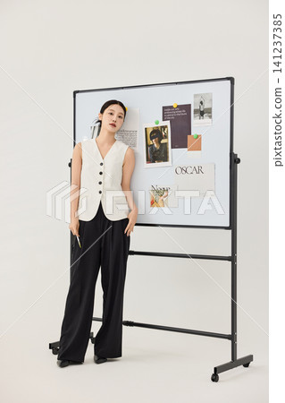 Asian businesswoman presenting ideas on a mood board in a studio office Asian businesswoman presenting ideas on a mood board in a studio office 141237385