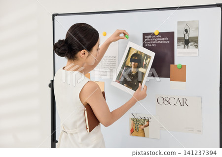 Professional woman planning a creative concept on a whiteboard Professional woman planning a creative concept on a whiteboard 141237394