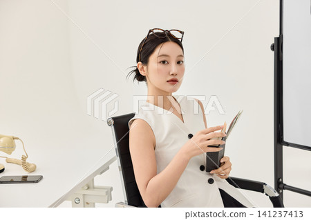 Female designer standing beside a project board with reference images Female designer standing beside a project board with reference images 141237413