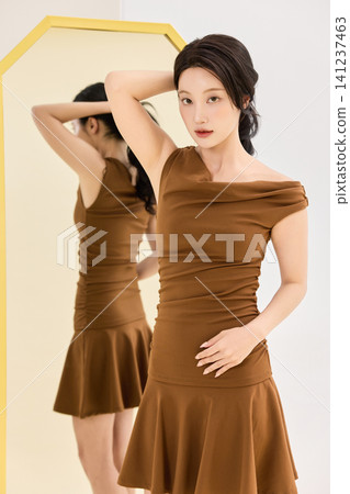 Asian woman preparing an outfit before going out Asian woman preparing an outfit before going out 141237463