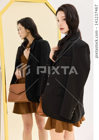 Asian woman preparing an outfit before going out Asian woman preparing an outfit before going out 141237467