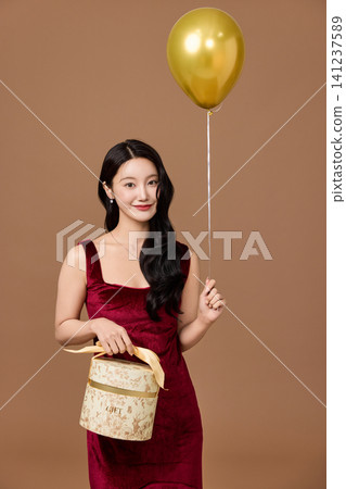 Celebration portrait with wrapped presents and party balloon Celebration portrait with wrapped presents and party balloon 141237589