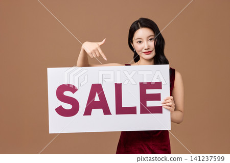 Shopping promotion portrait with a bold sale board Shopping promotion portrait with a bold sale board 141237599