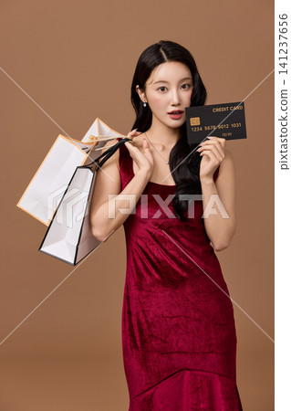 Fashionable shopper carrying multiple paper bags Fashionable shopper carrying multiple paper bags 141237656