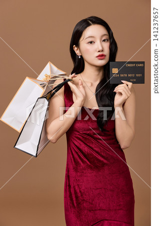 Retail promotion portrait with shopping bags and discount card Retail promotion portrait with shopping bags and discount card 141237657