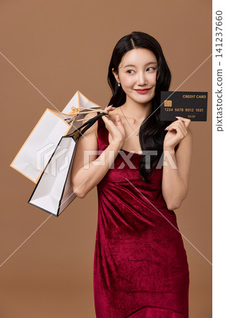 Fashionable shopper carrying multiple paper bags Fashionable shopper carrying multiple paper bags 141237660