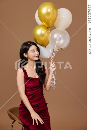 Festive party concept with an elegant woman in a red dress Festive party concept with an elegant woman in a red dress 141237665