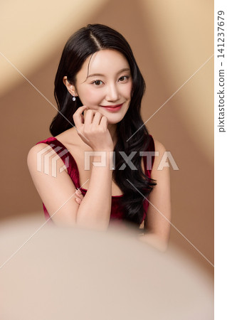 Festive party concept with an elegant woman in a red dress Festive party concept with an elegant woman in a red dress 141237679