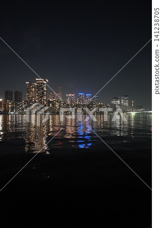 A night view of the Harumi high-rise apartment buildings and Tokyo Skytree from Toyosu Gururi Park (vertical orientation) A night view of the Harumi high-rise apartment buildings and Tokyo Skytree from Toyosu Gururi Park (vertical orientation) 141238705