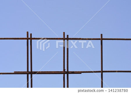 Rusty steel reinforcement mesh against a clear blue sky Rusty steel reinforcement mesh against a clear blue sky 141238780