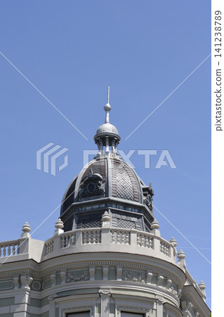 Historical building dome with metal spire against a blue sky Historical building dome with metal spire against a blue sky 141238789