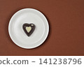 Heart Chocolate Praline on White Plate Top View 141238796