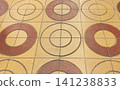 The geometric tile floor of the retro Showa-era shopping street, with its nostalgic texture of interconnected circular patterns. 141238833