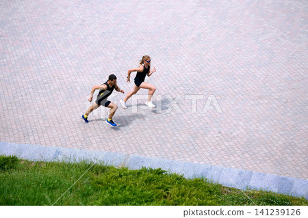 Overhead view of running pair with copy space on pavement. Overhead view of running pair with copy space on pavement. 141239126