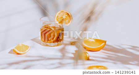Orange cocktail still life with citrus wedges, ice and wide restaurant copy space. Orange cocktail still life with citrus wedges, ice and wide restaurant copy space. 141239141